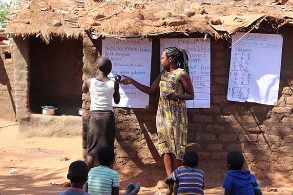 Temwa Chilenga teaching under difficult conditions